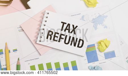 Notebook With A Business Notes Tax Refund On The Office Table With Tools. Concept Tax Refund With El