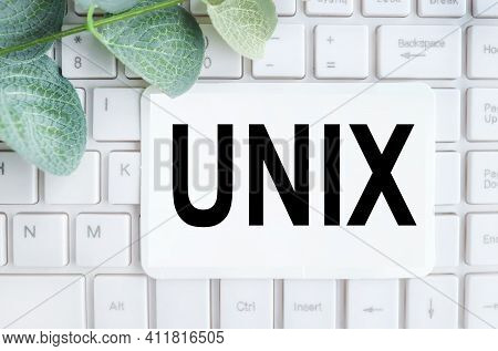 Word Unix. Text On White Notepad Paper On White Keyboard.