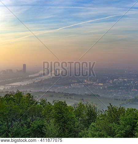 Scenic View To Vienna And River Danube In Dawn With Forest In Foreground