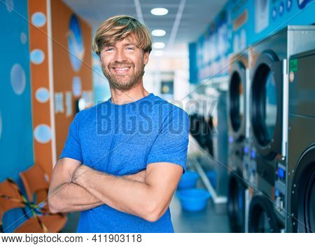 Caucasian man smiling happy standing at laundry room