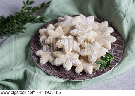 Sable Sugar Cookies With Sugar Powder On A Plate On Gteen Napkin, Green Leavs In Background. Selecti