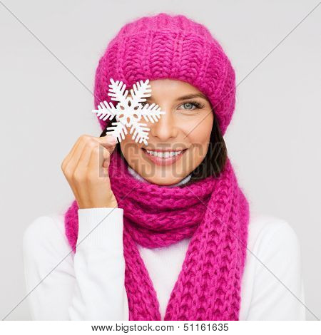 winter, people, happiness concept - woman in hat and muffler with big snowflake