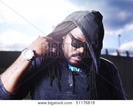 cool african man showing dreads with lens flare