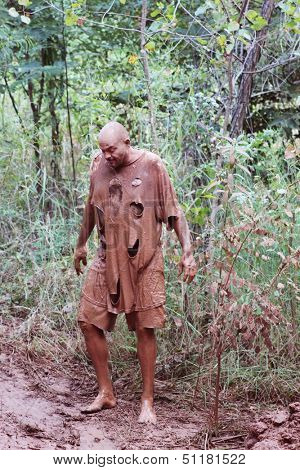 MUSKOGEE, OK - SEPT. 14 : Actors portraying zombies wait for runners to cross their mud pit  during the Castle Zombie Run at the Castle of Muskogee in Muskogee, OK on September 14 , 2013.