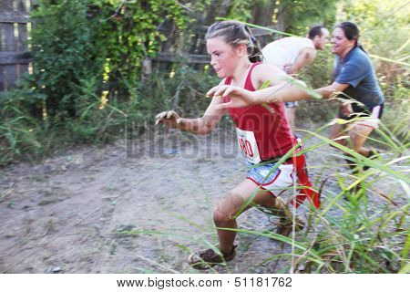 MUSKOGEE, OK - Sept. 14: Zombies attack runners and attempt to grab their red life flags  during the Castle Zombie Run at the Castle of Muskogee in Muskogee, OK on September 14, 2013.