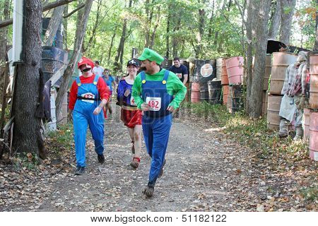 MUSKOGEE, OK - Sept. 14: Athletes dressed as Mario Brothers avoid zombies during the Castle Zombie Run at the Castle of Muskogee in Muskogee, OK on September 14, 2013.