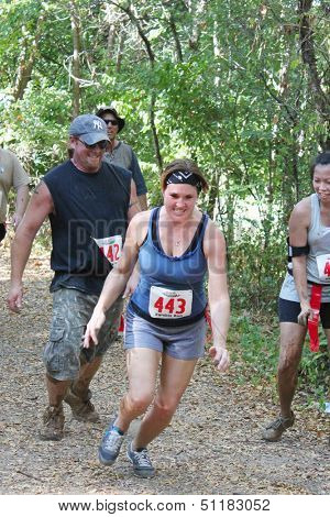 MUSKOGEE, OK - Sept. 14: Runners hurry through zombie-infested forest during the Castle Zombie Run at the Castle of Muskogee in Muskogee, OK on September 14, 2013.