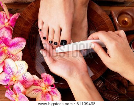 Pedicurist Master Makes Pedicure On Woman's Legs