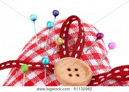 Colored pinheads in pin-cushion isolated on white