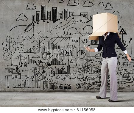Businesswoman using mobile phone wearing carton box on head