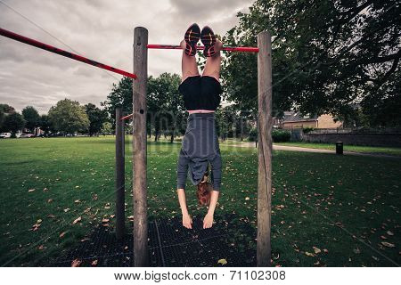 Woman Dangling From Pullup Bars