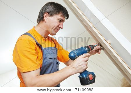 Male handyman carpenter at interior wood door lock installation