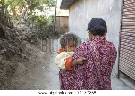 KATHMANDU, NEPAL - DEC 22, 2013: Unidentified local child near their homes in a poor area of the city. The caste system is still intact today but the rules are not as rigid as they were in the past