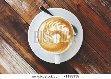 Coffee cup on wooden table, artistic photo