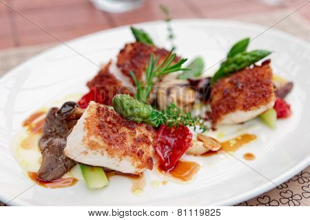 Coalfish fillet with mushrooms and asparagus on plate