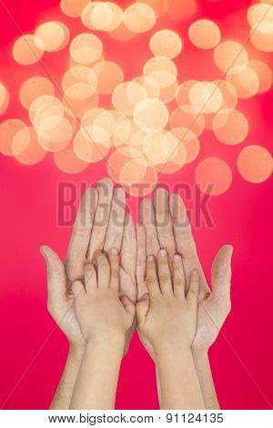 Father And Son Holding Hands On Christmas Lights Background