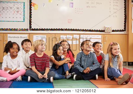 Elementary school kids sitting on classroom floor