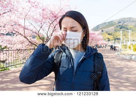 Woman suffer from allergy from pollen allergy at sakura season