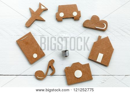 Cardboard web icons  and light bulb on blue background