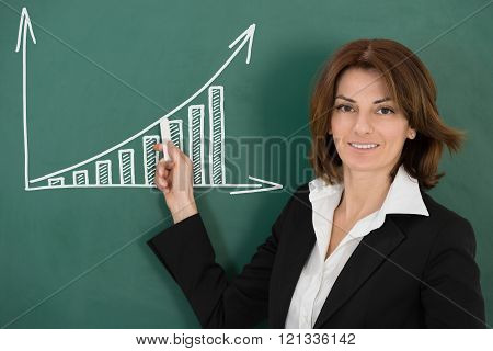 Young Happy Female Teacher Holding Chalk