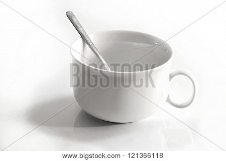 White Cup And A Steel Teaspoon