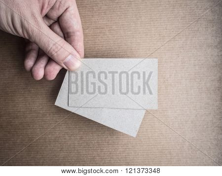 Mockup of two business cards in man's hand
