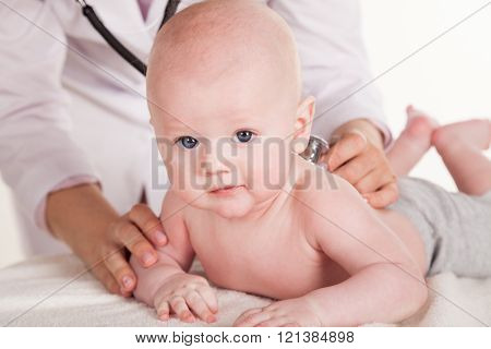 the doctor listens to the baby newborn