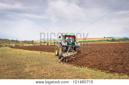 Karlovo, Bulgaria - August 22Th, 2015: Ploughing A Field With John Deere 7230R Tractor. John Deere 8