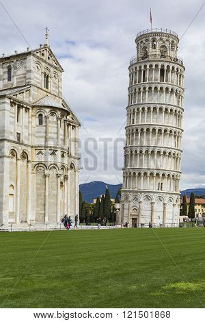 Piza, Italy - 10 March, 2016: View Of Leaning Tower And The Basilica, Piazza Dei Miracoli, Pisa, Ita