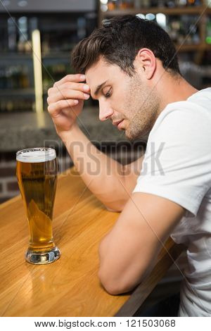 Tired man having a beer in a pub