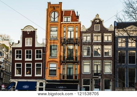 AMSTERDAM NETHERLANDS - 16TH FEBRUARY 2016: The outside of colorful thin buildings in the Centrum area of Amsterdam during the day.