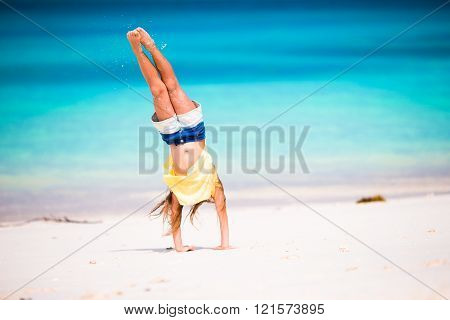 Adorable little girl during beach vacation have fun