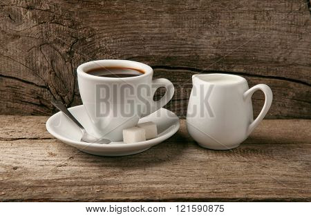 Cup of coffee espresso with with milk closeup on wooden background. Coffee background
