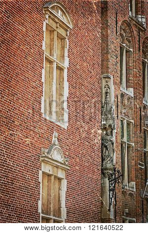 Old picture with architectural facade detail at one old building placed in Bruges Belgium. Vintage processing.