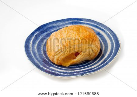 Cream puff on the blue plate with white stripes