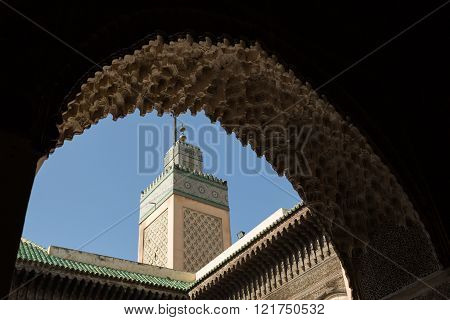 view of the minaret of the 14th century Bou Inania Medrese in the ancient medina of Fes, Morocco