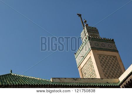view of the minaret of the 14th century Bou Inania Medrese in the ancient medina of Fes, Morocco