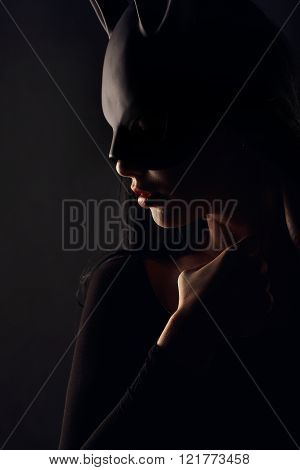 Sexy beautiful charming woamn in black rabbit mask and elegant dress studio