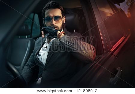 Handsome fashion man driving a car