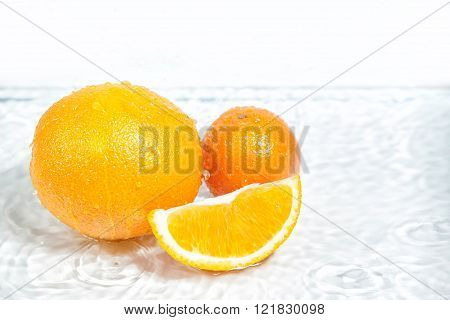 Orange Fruit In Section In White Water