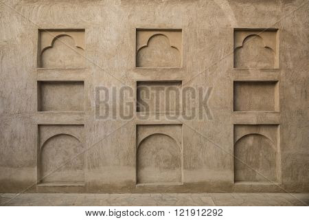 Many small arches on the grunge wall. Interior details of old arabic house.