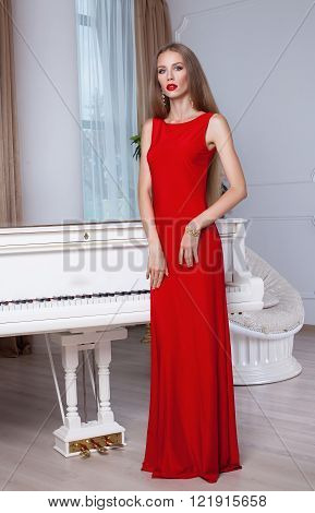 Beautiful blonde woman in red evening dress