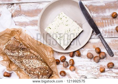 Cheese With Dill And Bread Huzelnuts On Wooden Board