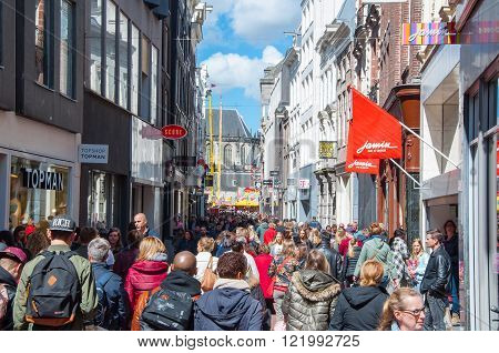 AMSTERDAM-APRIL 30: People go shopping on Kalverstraat street on April 30 2015 the Netherlands. The Kalverstraat is a busy shopping street of Amsterdam the capital of the Netherlands.