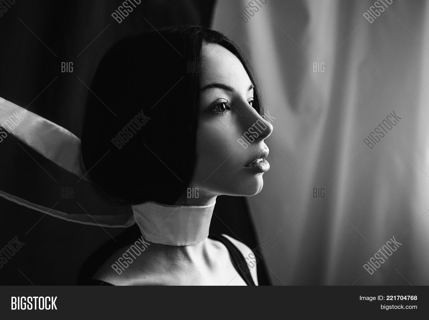 Emotional portrait of brunette girl with long straight black hair black and white art monochrome