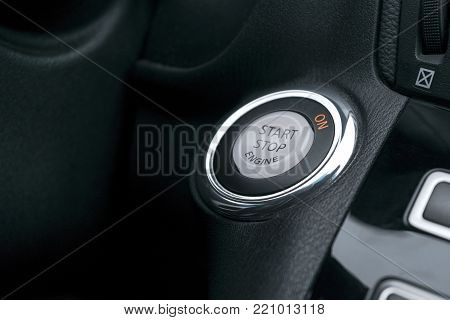 Car dashboard with focus on engine start stop button, Modern car interior details. start/stop
