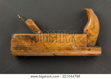 Old carpenter tool wood Plane on a gray background