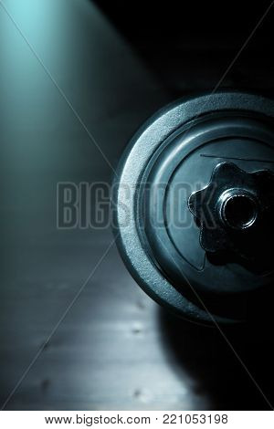 sports dumbbell view in profilesport dumbbell view in profile on a dark background
