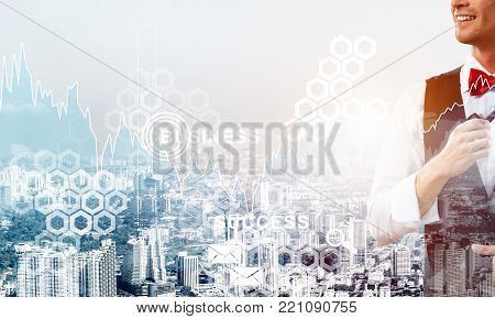 Double exposure of confident and young businessman in smart-casual wear smoking pipe and modern cityscape with business and media interface. Concept of new technologies for modern business.