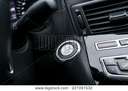Car dashboard with focus on engine start stop button, Modern car interior details. Start/stop